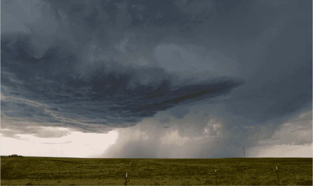 Looking at a storm in the distance over fields