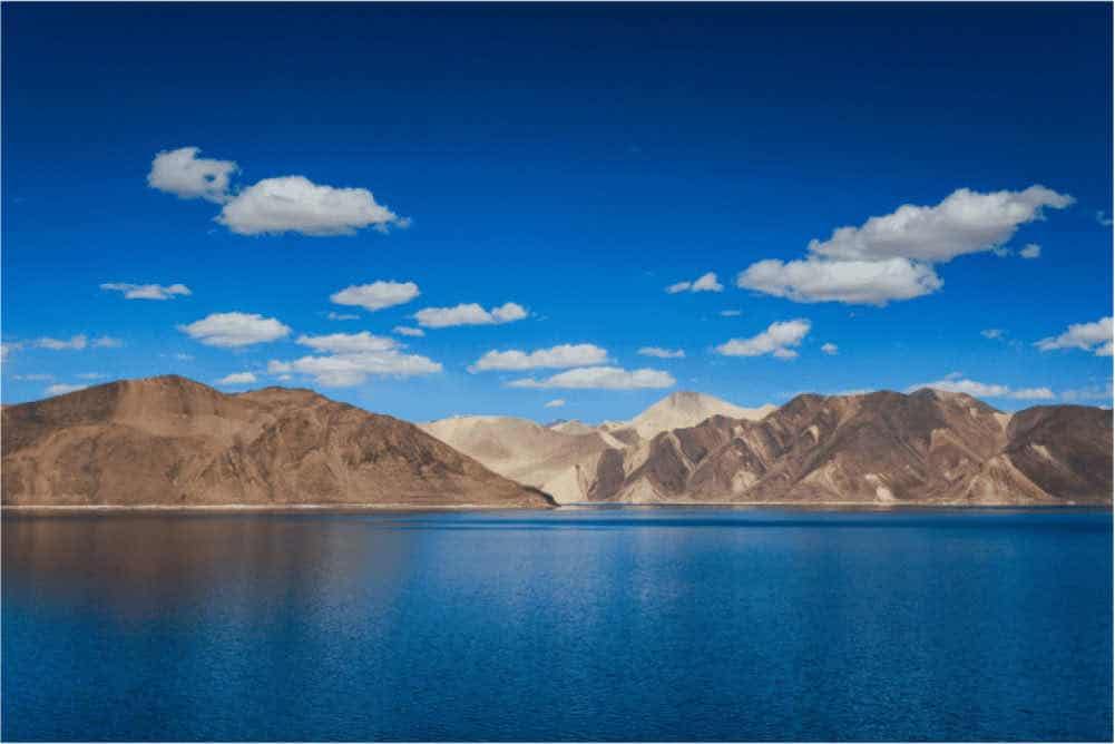 A large lake with mountains in the background