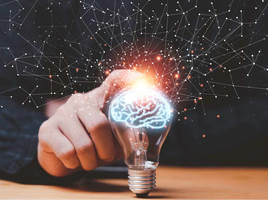 Man touching lightbulb, symbolizing the Buddhist science of mind