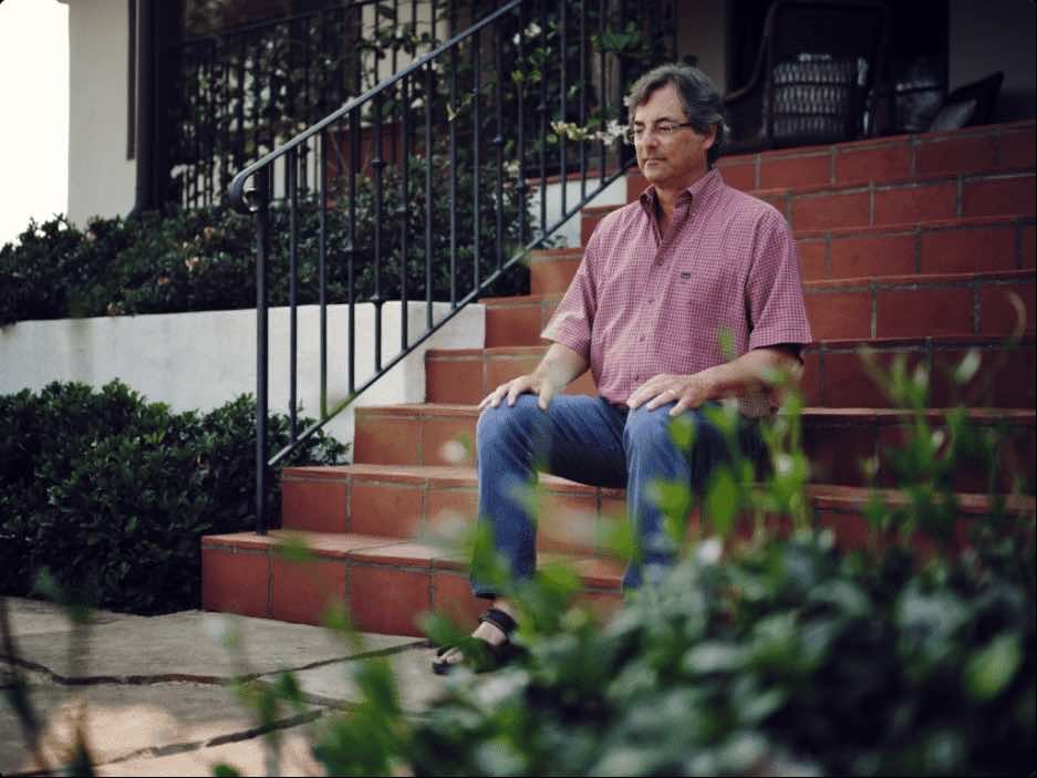 Mindwork's Founder, Bart, meditating outside on a set of steps